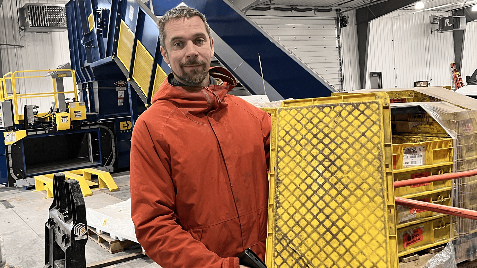 Thomas Dambo holding a yellow plastic crate